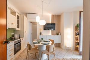 a kitchen and dining room with a table and chairs at Luxury Garden Suite with Private Heated jacuzzi in Perugia