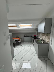 an empty kitchen with a sink and a table at Mansarda al mare in Tortoreto Lido