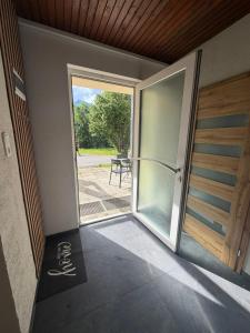 an open door to a patio with a table outside at Patrycja 2 Top 1 in Ehenbichl +1 photo