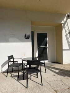 two chairs and a table in front of a building at Patrycja 2 Top 1 in Ehenbichl