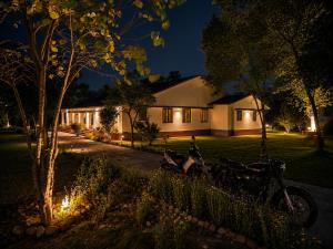 a house with motorcycles parked in the yard at night at Doi Stays Dak Bungalow in Almora +44 photos