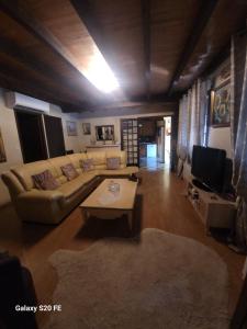 a living room with a couch and a table at La symphonie des oiseaux in Villelongue-dʼAude