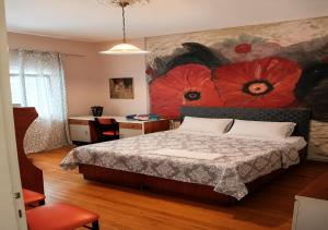 a bedroom with a bed with a painting on the wall at Kolhida home in Kilkis