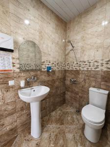 a bathroom with a toilet and a sink at Hotel Kopala Ureki in Ureki +52 photos