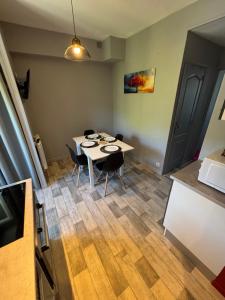 a room with a table and chairs in it at Le repos des sommets in La Bourboule +16 photos