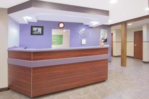 a lobby of a muncie clinic with a reception counter at Microtel Inn and Suites Manistee in Manistee