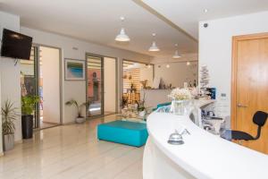 a kitchen and living room with a white counter top at Grand Boutique in Vasiliki