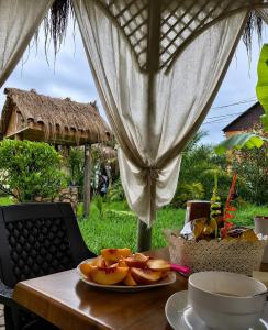 a table with a plate of fruit on top of it at Hotel Kopala Ureki in Ureki