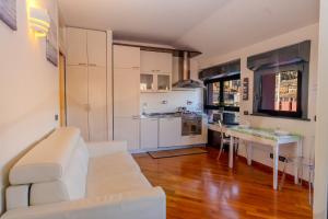 a living room with a white couch and a table at Acquarium dream apartment kate in Genoa