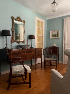 a living room with a desk and a mirror at L Epernon in Alençon +36 photos