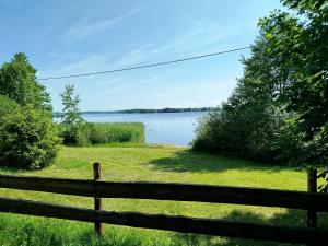 a view of a lake from a fence at Pole u Daniela in Grzybina +4 photos