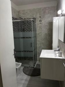 a bathroom with a shower and a sink and a toilet at Pop Art Apartament in Treviso +10 photos