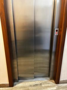 a stainless steel elevator in a building at Pop Art Apartament in Treviso