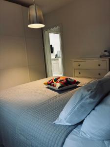 a bedroom with a bed with a pillow and a mirror at Pop Art Apartament in Treviso