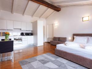 a large bedroom with a bed and a kitchen at SOUL OF TRENTO Exclusive Jacuzzi Loft in Trento