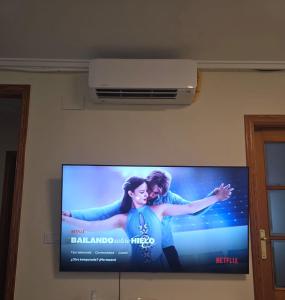 a flat screen tv hanging on a wall at Piso Delfin Playa in Moncófar