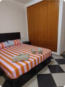 a bedroom with a large bed with towels on it at Piso Delfin Playa in Moncófar