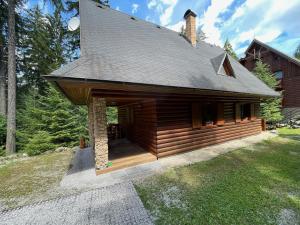 a log cabin with a gambrel roof at Chata Harmony in Ružomberok