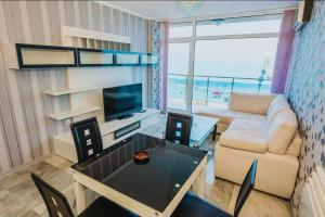 a living room with a couch and a table at Family Complex Gallery - Sunny Beach in Sunny Beach