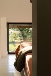 a room with a bed and a window with a view at Maison d'hôtes le détour en pleine nature in Channay-sur-Lathan
