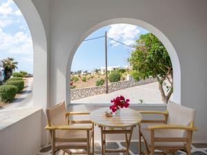 a table and chairs in a room with a window at Akteon Hotel in Logaras