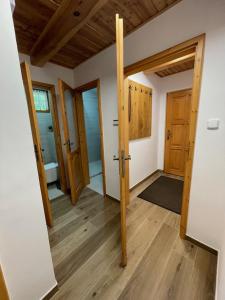 an empty room with wooden doors and wooden floors at Chata Harmony in Ružomberok +27 photos