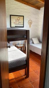 a small room with two beds in a room at Armonía in Villa Serrana