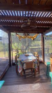 a table and chairs on the porch of a house at Armonía in Villa Serrana +26 photos