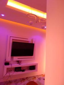 a room with a flat screen tv on a wall at Residence Angevita in Edéa