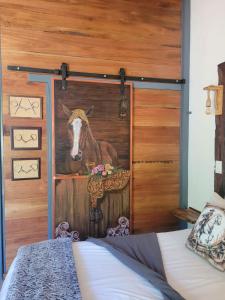 a mural of a horse on a door in a bedroom at Cozy Guest in Graskop