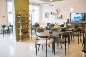 a restaurant with tables and chairs in a room at Mostay Boutique Hotel in Mostar