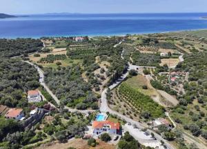 an aerial view of a house and the ocean at Villa Karras in Pythagoreio