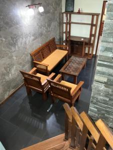 a room with a table and chairs and a piano at Villa Sadalla in Hikkaduwa