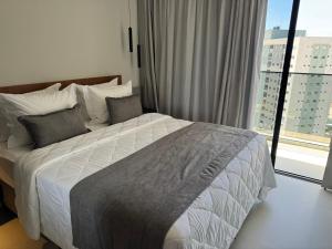 a bedroom with a bed and a large window at Salinas Beach Resort in Salinópolis +35 photos