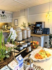 a kitchen with several plates of food on a counter at Hotel Amadeus Halmstad in Halmstad
