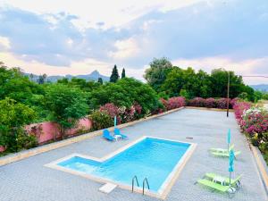 a swimming pool with two lounge chairs and a swimming pool at Villa Konari in Tolo
