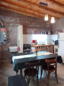 a kitchen with a table and chairs in a room at El Espinillo in La Falda