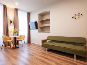 a living room with a couch and a table at SOUL OF TRENTO San Martino in Trento