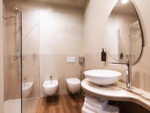 a bathroom with a sink and a shower and a toilet at SOUL OF TRENTO San Martino in Trento