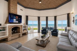 a living room with a couch and a fireplace at Las Palmas Resort in Puerto Peñasco