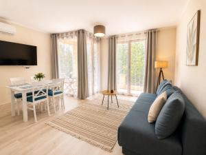 a living room with a blue couch and a table at Adriatic Monte Apartments in Tušupi