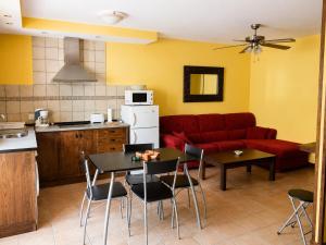 a living room with a couch and a table and chairs at Posada La Vieja Escuela Valles Pasiegos in San Roque de Ríomiera