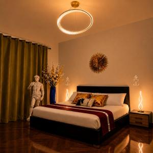 a bedroom with a bed and a person standing next to a window at UTOPIA "The Art of Bed & Breakfast" in Marigliano