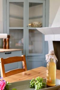 a table with a bottle of juice and a plate of grapes at Casa do Sol in Pedrógão +16 photos
