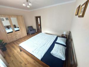a bedroom with a bed and a chair in it at Dom u Tosi pod Zatorem in Spytkowice