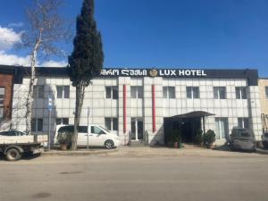 a building with cars parked in front of it at Lux hotel in Tbilisi City