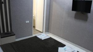 a room with a door with a towel on the floor at Lux hotel in Tbilisi City