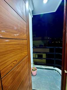 a door with a potted plant next to a window at Lalitpur stay in Pātan