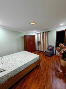 a bedroom with a bed and a wooden floor at Lalitpur stay in Pātan