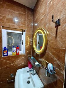 a bathroom with a sink and a mirror at Lalitpur stay in Pātan